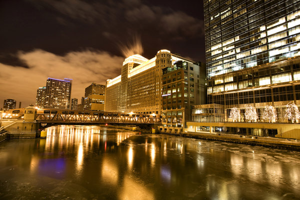 The Chicago River at night with the buildings lit up