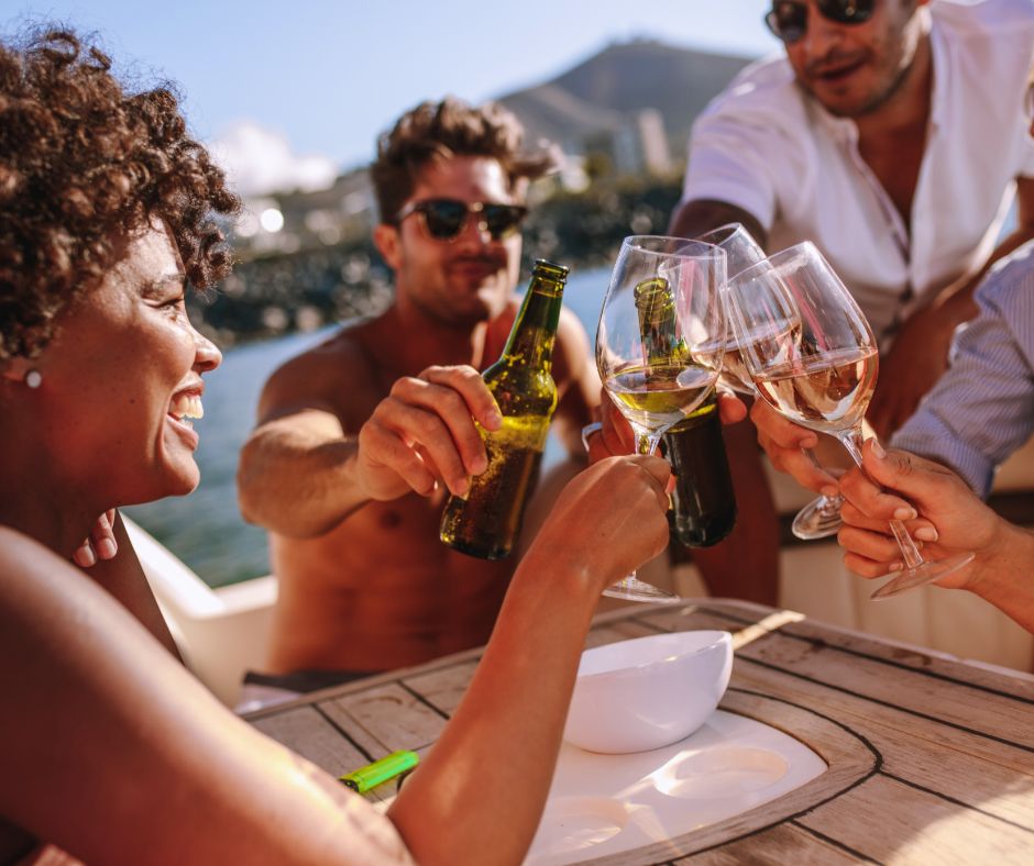 young people enjoying drinks on a boat
